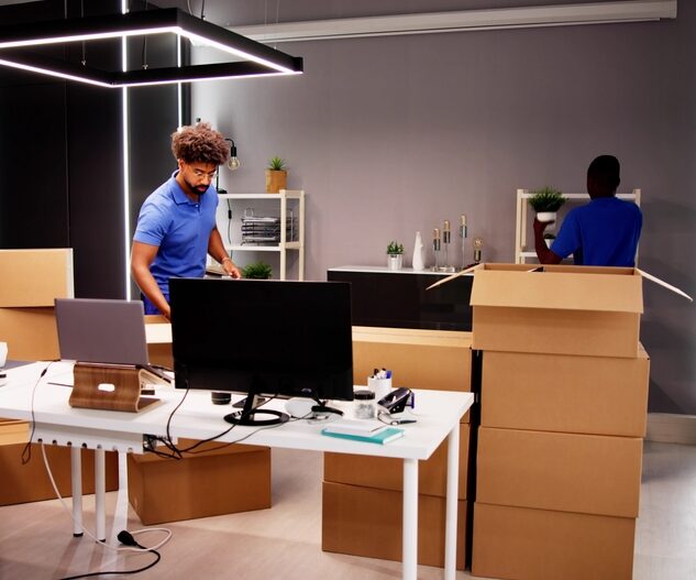 Professional,Movers,Packing,Boxes,In,Modern,Office